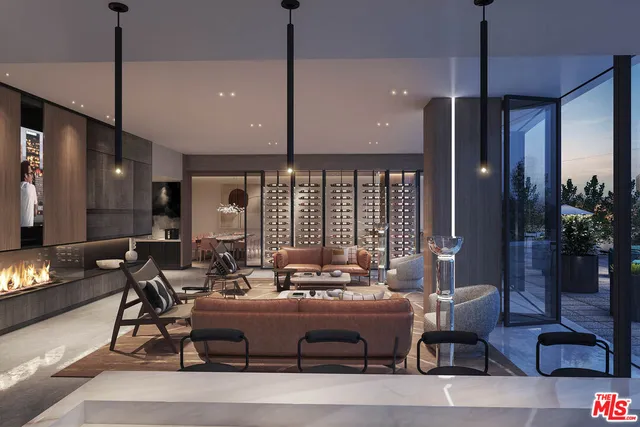 a living room with couches and kitchen view with wooden floor