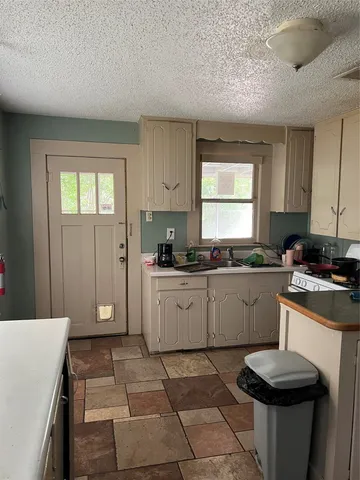 a bathroom with a sink vanity mirror and toilet