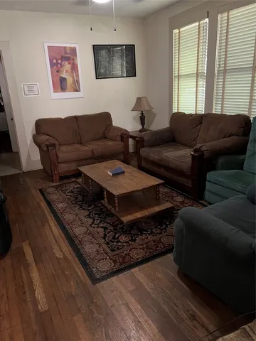 a view of room with furniture and wooden floor