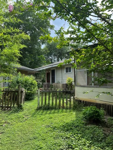 a backyard of a house with yard and outdoor seating