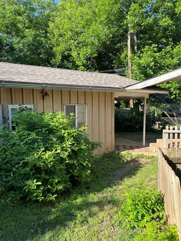 a view of a house with backyard and garden