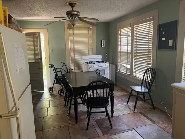 a view of a dining room with furniture and window