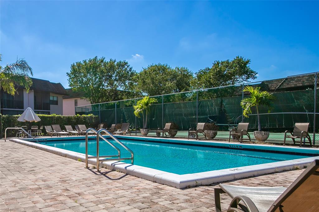 10557 Northwest 10th Street, Unit 101 Pembroke Pines, FL 33026 - Photo 17 of 19 a view of a chairs and a table in the terrace