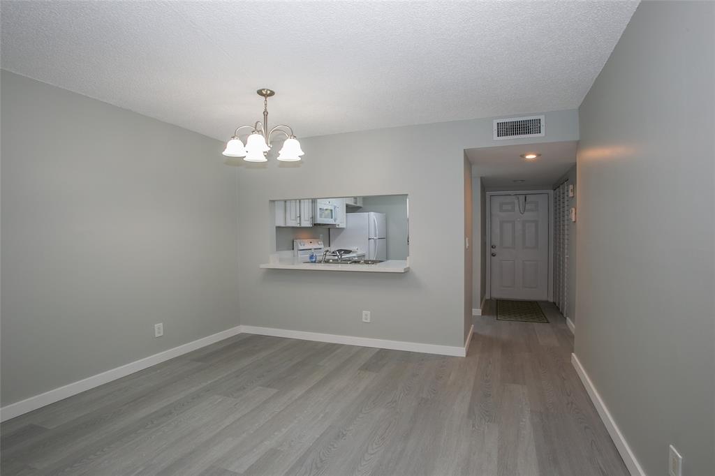 10557 Northwest 10th Street, Unit 101 Pembroke Pines, FL 33026 - Photo 6 of 19 wooden floor in an empty room with a window