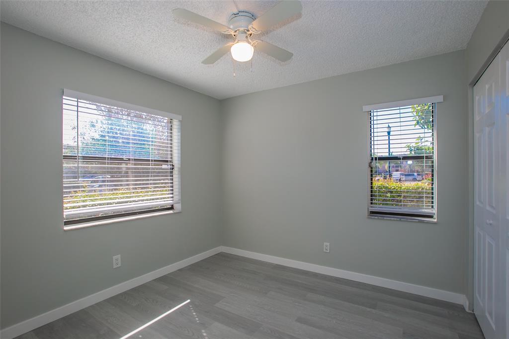 10557 Northwest 10th Street, Unit 101 Pembroke Pines, FL 33026 - Photo 7 of 19 a view of an empty room with a window and a ceiling fan