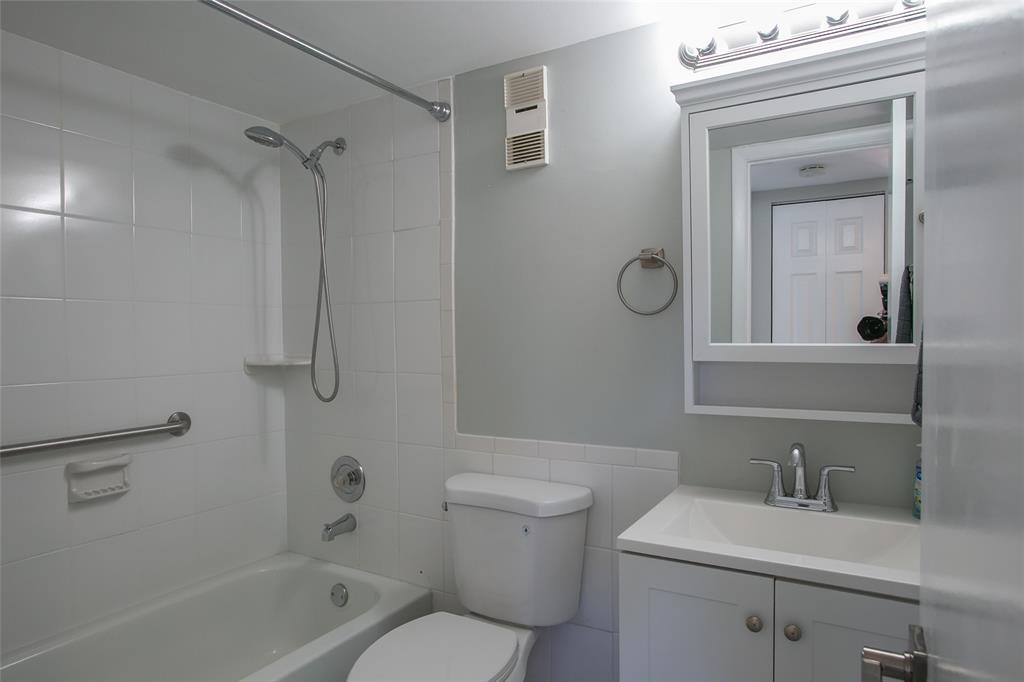 10557 Northwest 10th Street, Unit 101 Pembroke Pines, FL 33026 - Photo 8 of 19 a bathroom with a granite countertop toilet a sink and a mirror