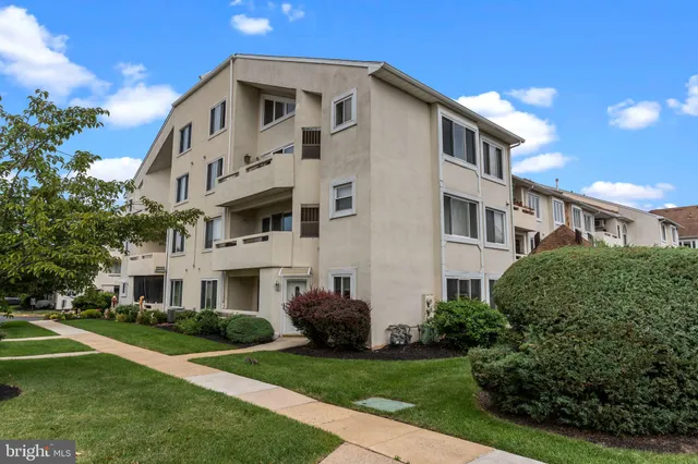 a large white building with a yard in front of it