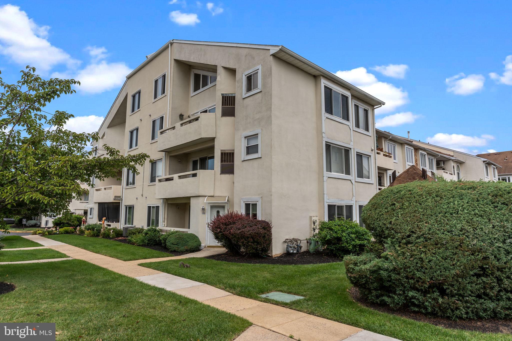 a large white building with a yard in front of it