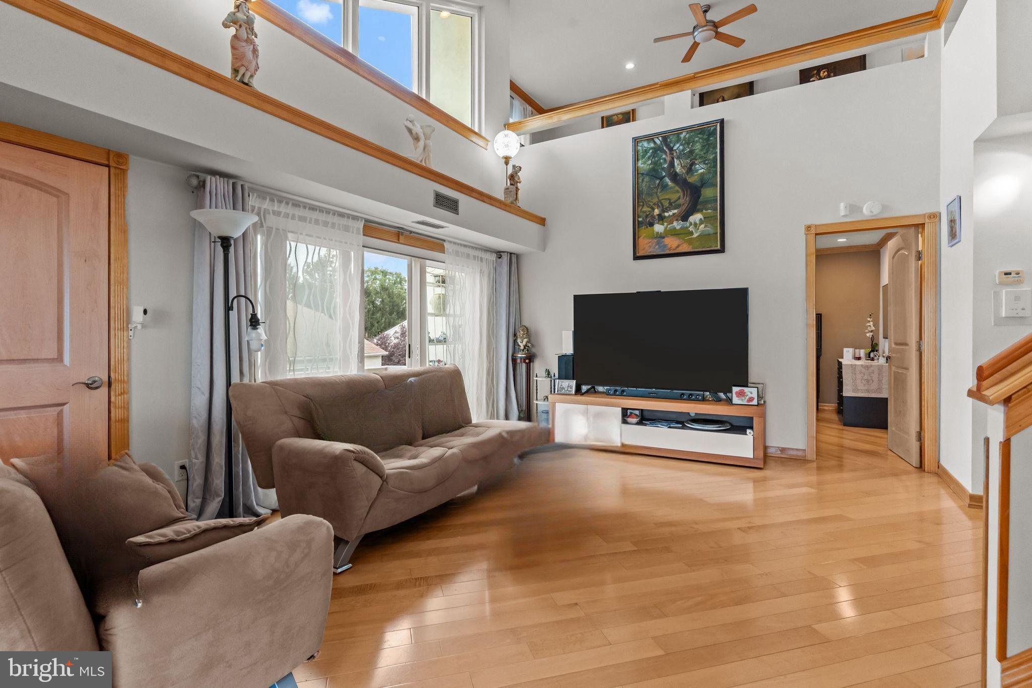 75 Bonnie Gellman Court, Unit D75 Philadelphia, PA 19114 - Photo 11 of 37 a living room with furniture and a flat screen tv