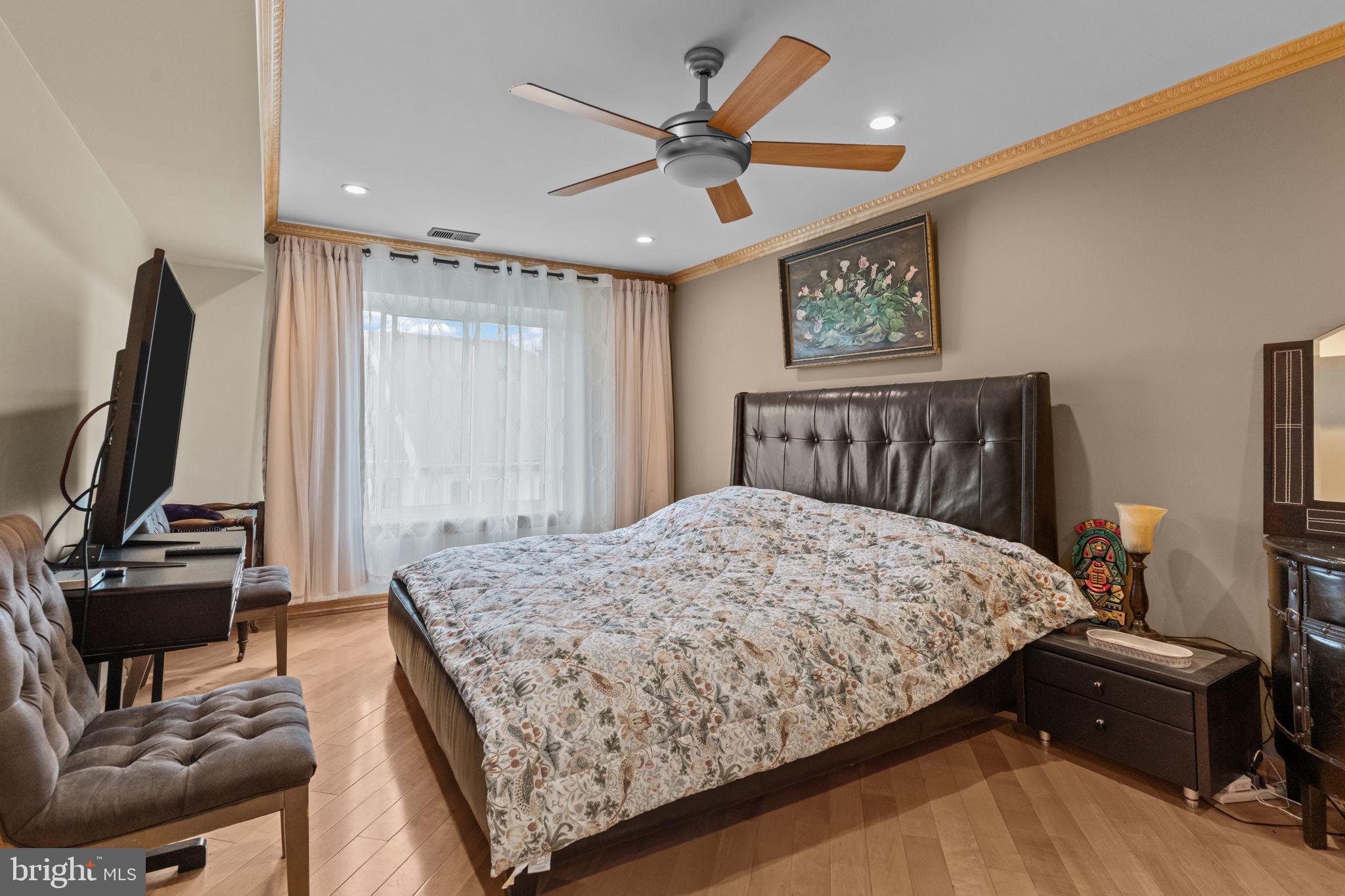 75 Bonnie Gellman Court, Unit D75 Philadelphia, PA 19114 - Photo 13 of 37 a bedroom with a bed and a flat screen tv