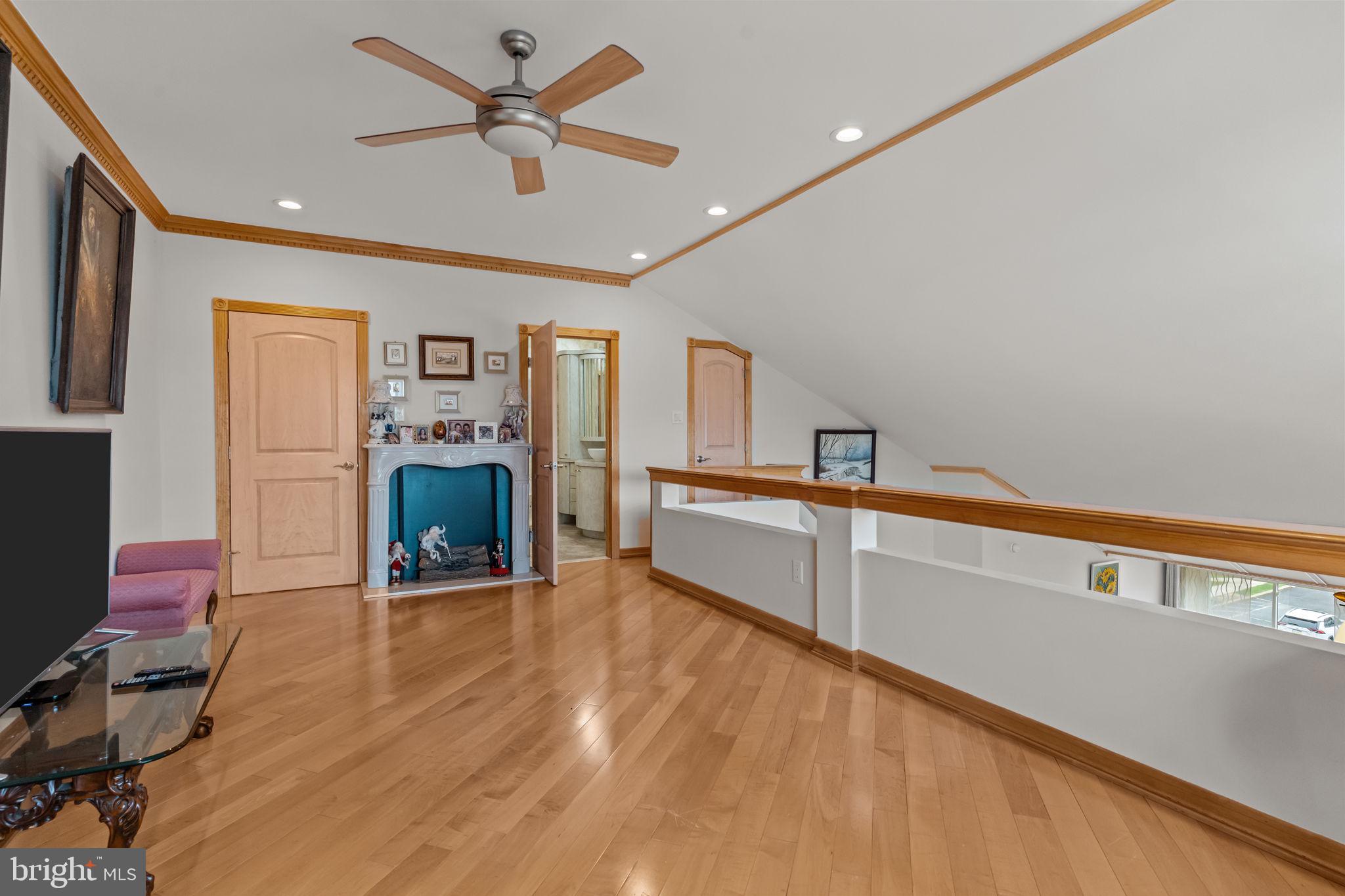 75 Bonnie Gellman Court, Unit D75 Philadelphia, PA 19114 - Photo 17 of 37 a living room with furniture and a fireplace