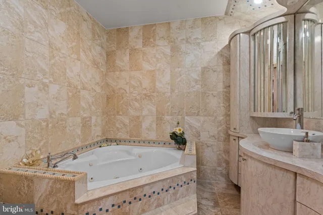 a bathroom with a glass shower door and a sink
