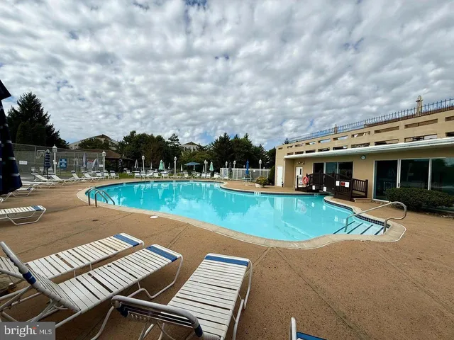a view of an empty room with a floor to ceiling window and an entryway