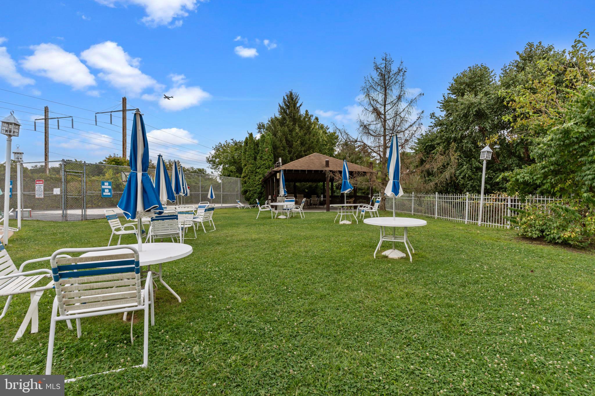75 Bonnie Gellman Court, Unit D75 Philadelphia, PA 19114 - Photo 29 of 37 a view of a chair and table in the garden