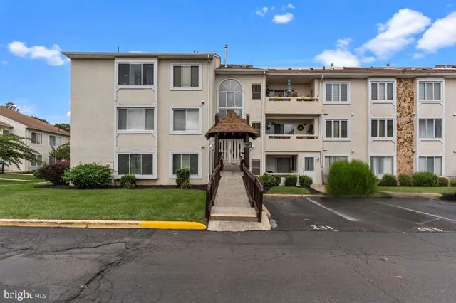 a front view of residential houses with yard and green space