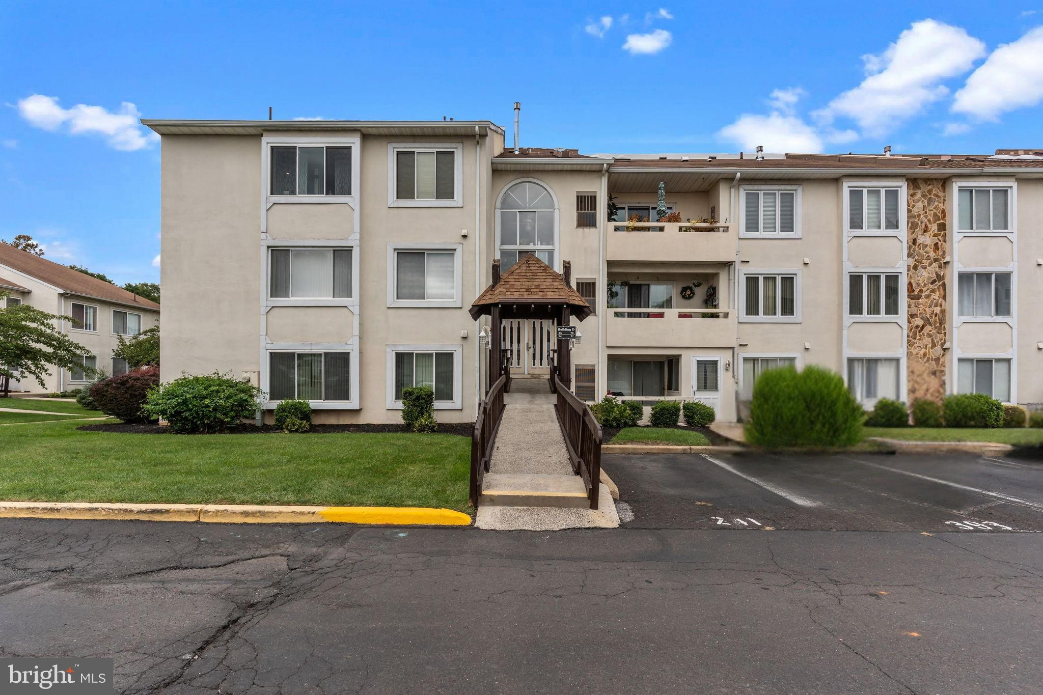 75 Bonnie Gellman Court, Unit D75 Philadelphia, PA 19114 - Photo 3 of 37 a front view of residential houses with yard and green space