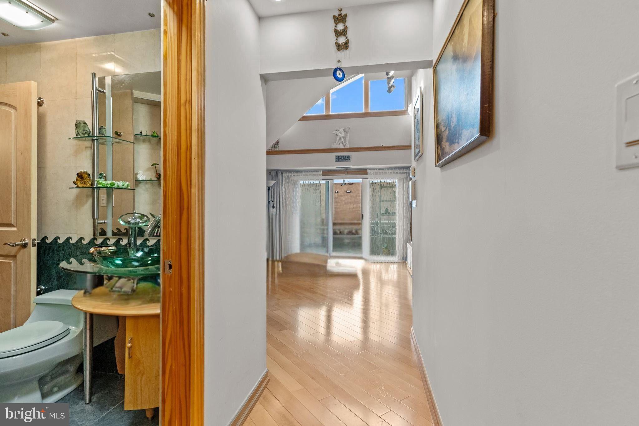 75 Bonnie Gellman Court, Unit D75 Philadelphia, PA 19114 - Photo 4 of 37 a bathroom with a toilet sink and mirror