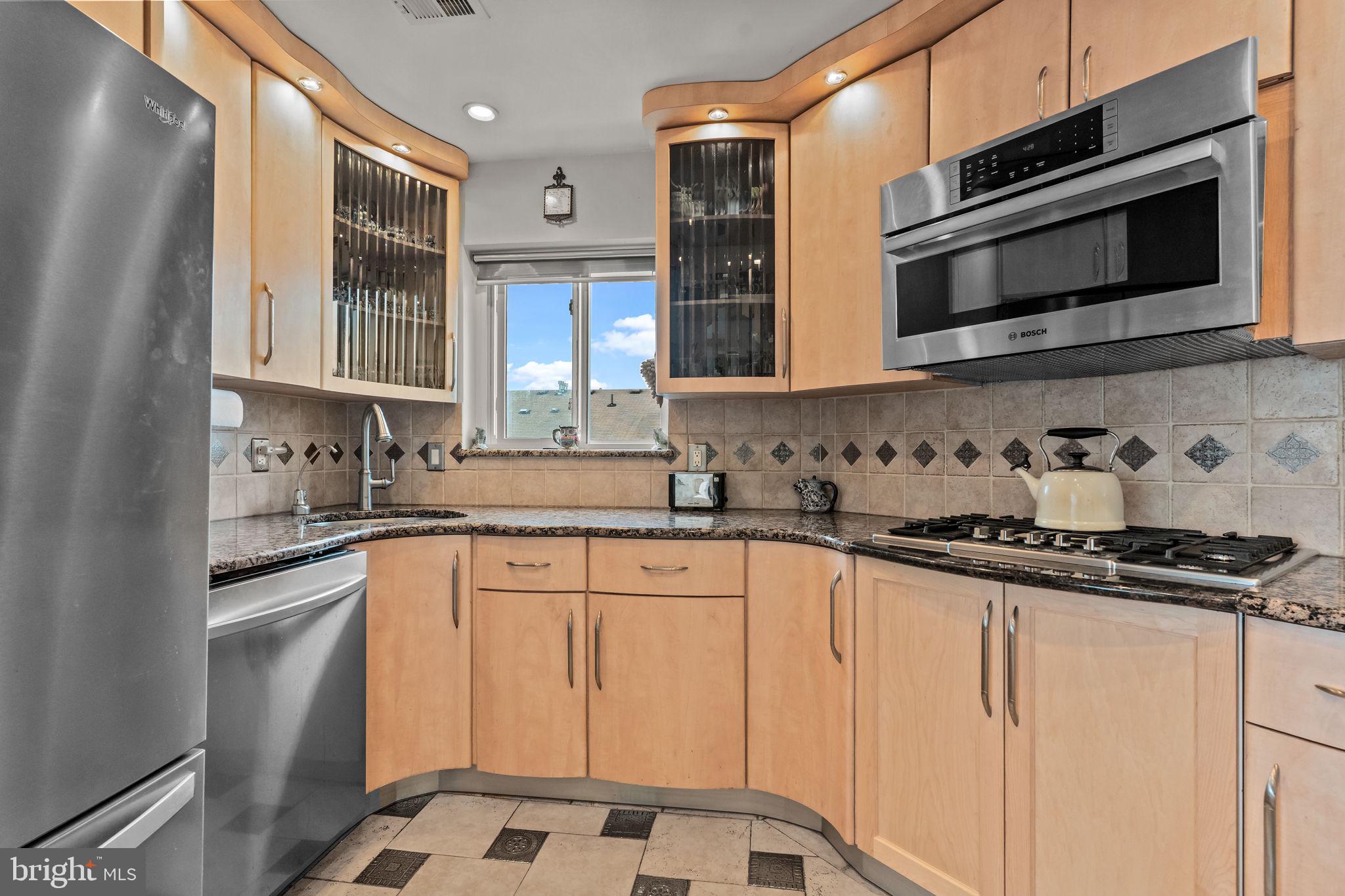 75 Bonnie Gellman Court, Unit D75 Philadelphia, PA 19114 - Photo 7 of 37 a kitchen with granite countertop white cabinets and stainless steel appliances
