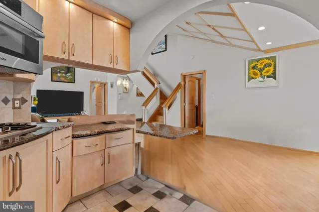 a kitchen with appliances cabinets and a counter top space