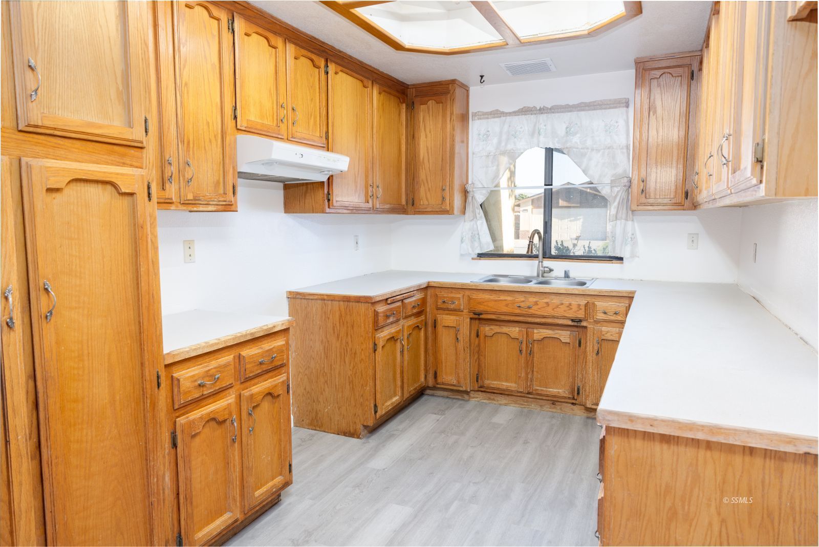 820 Walker Lane Ridgecrest, CA 93555 - Photo 14 of 27 a kitchen with wooden cabinets and a sink