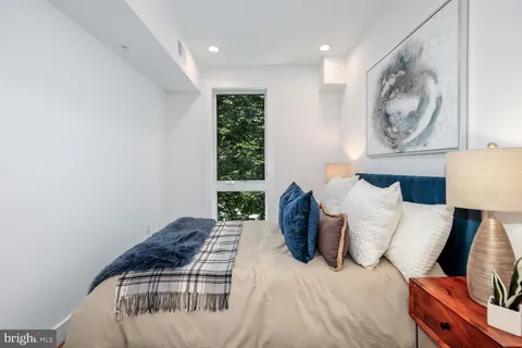 a bedroom with bed and a window