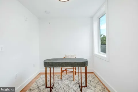 a view of a room with wooden floor