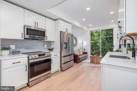 a kitchen with a stove a sink and a microwave