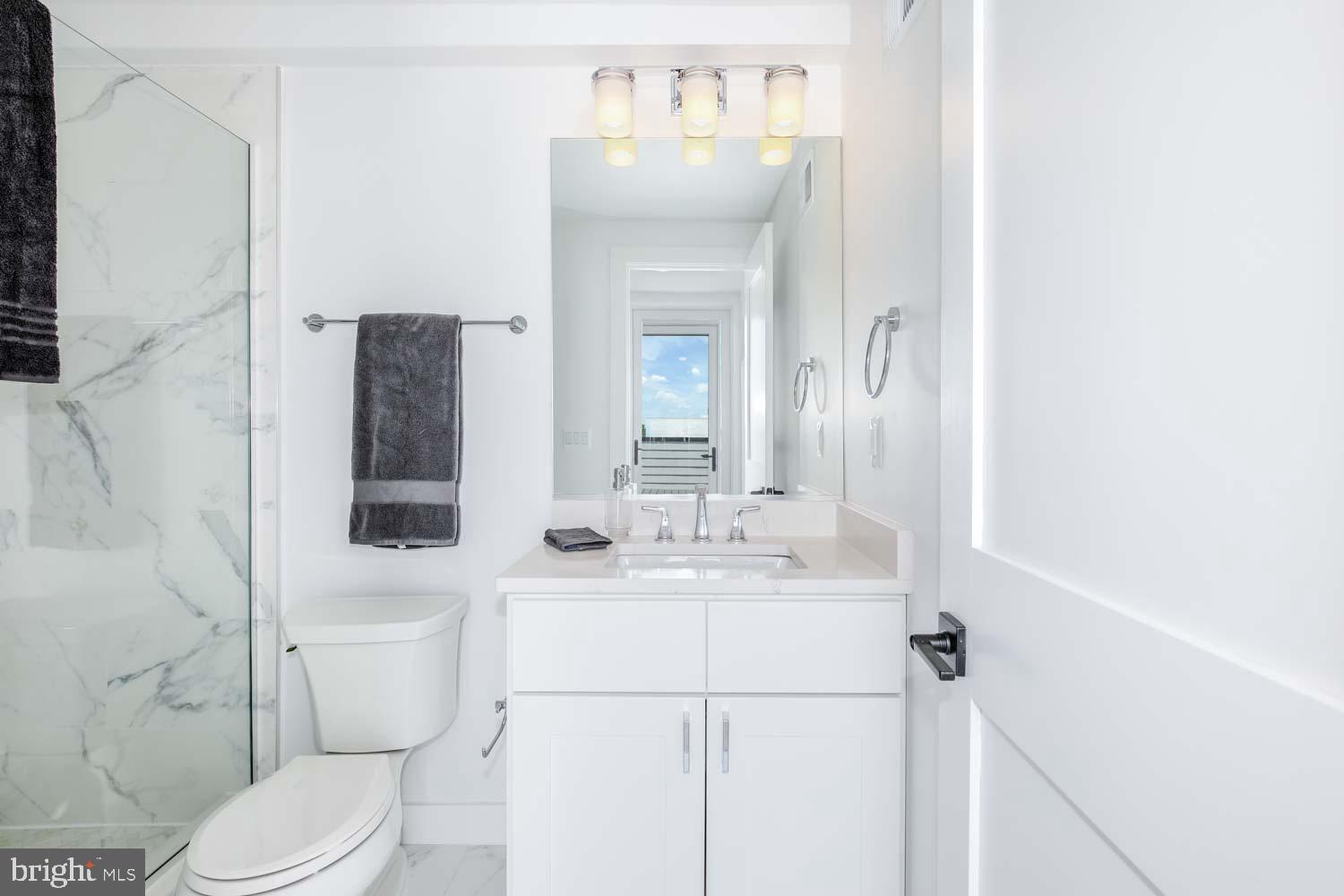 2601 30th Street Northeast, Unit 11 Washington, DC 20018 - Photo 21 of 32 a bathroom with a sink a toilet and shower