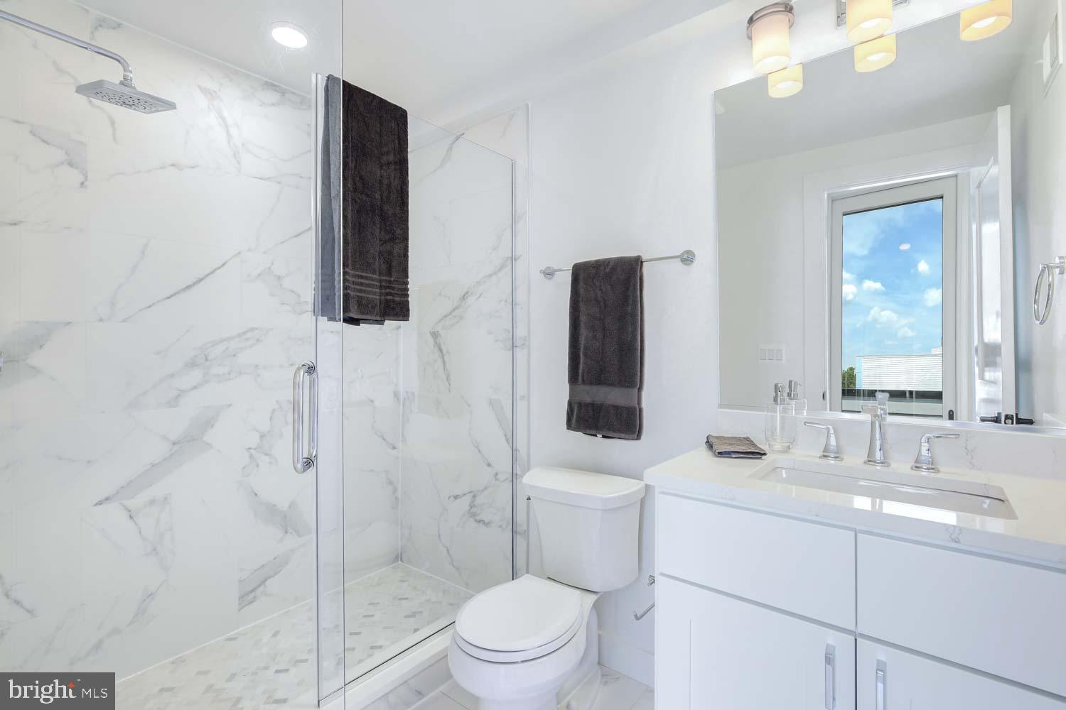 2601 30th Street Northeast, Unit 11 Washington, DC 20018 - Photo 22 of 32 a bathroom with a sink toilet and shower