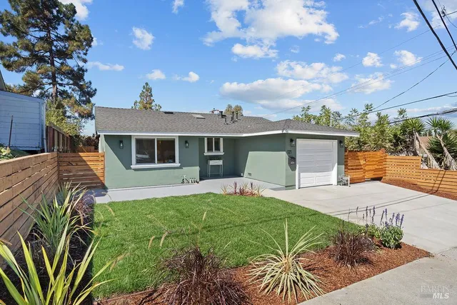 a front view of a house with a yard and porch