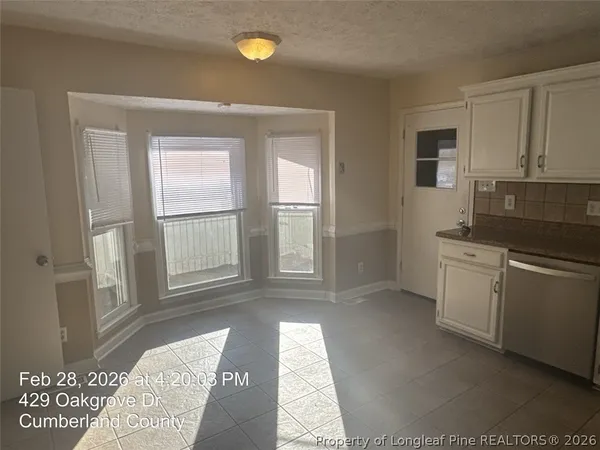 a kitchen with a refrigerator and window