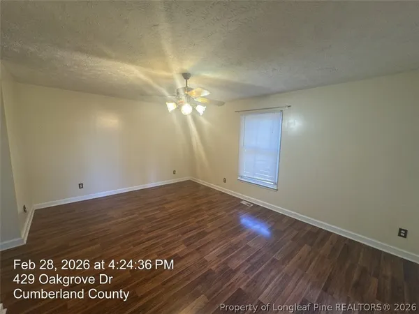 an empty room with wooden floor