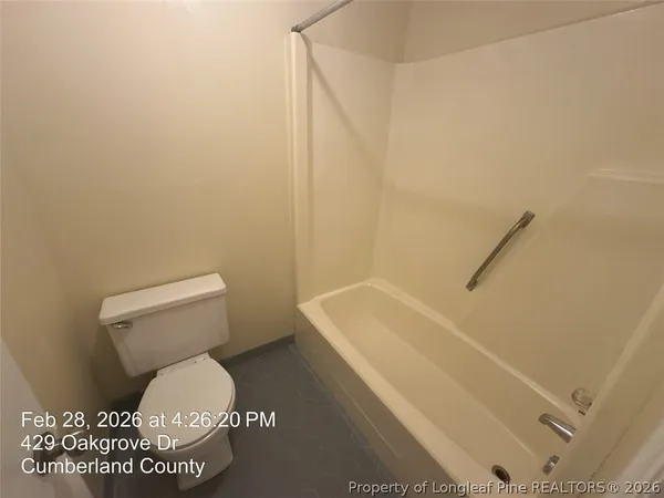 a bathroom with a toilet and a bathtub