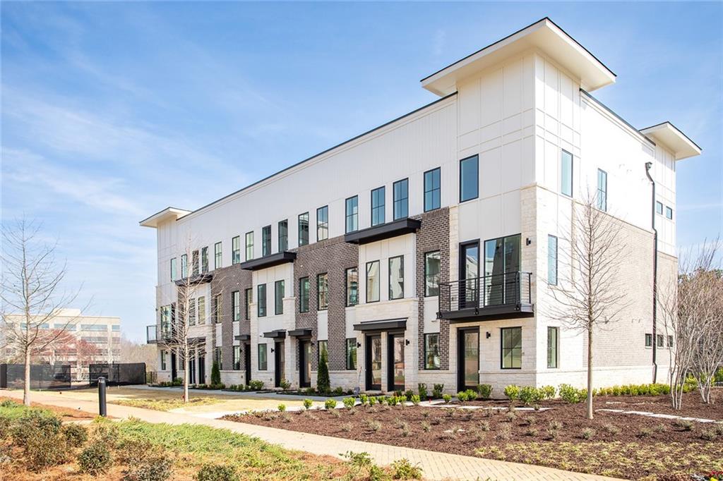 7230 Summit Place Alpharetta, GA 30009 - Photo 21 of 37 a front view of a building with a yard