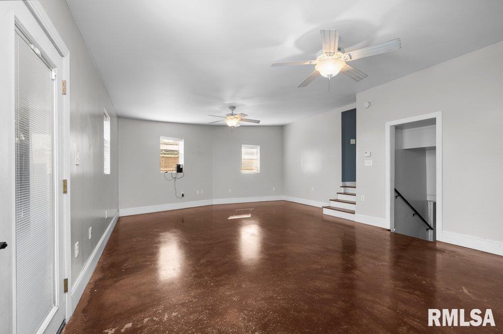 216 North Boss Street Kewanee, IL 61443 - Photo 12 of 36 a view of an empty room with wooden floor and a window