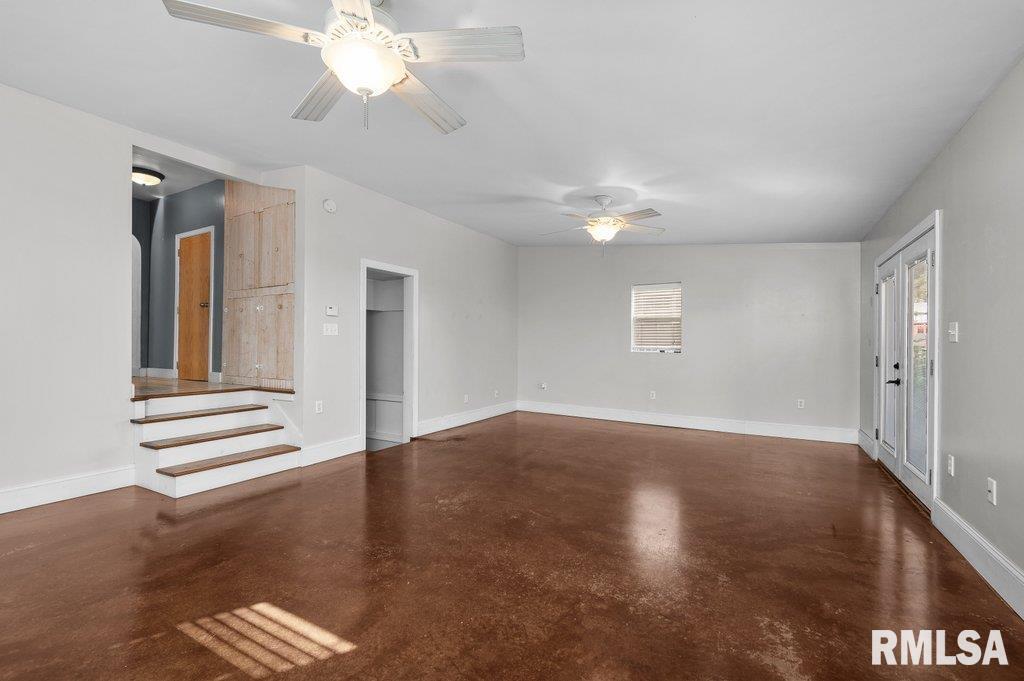 216 North Boss Street Kewanee, IL 61443 - Photo 13 of 36 a view of an empty room with wooden floor and a window