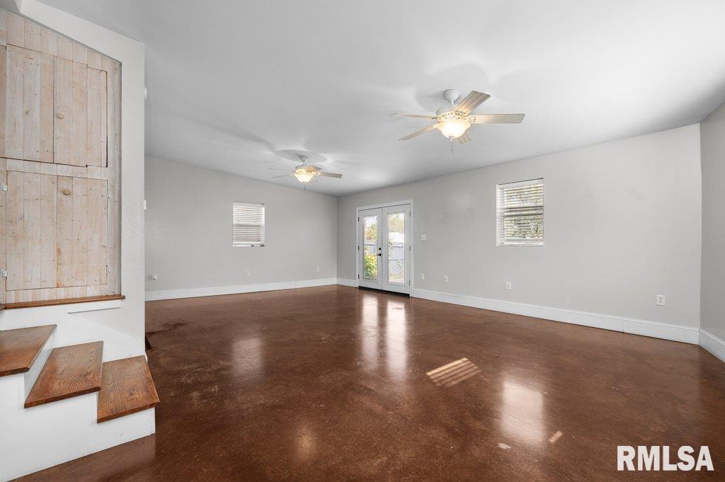 216 North Boss Street Kewanee, IL 61443 - Photo 14 of 36 a view of an empty room with wooden floor and a window