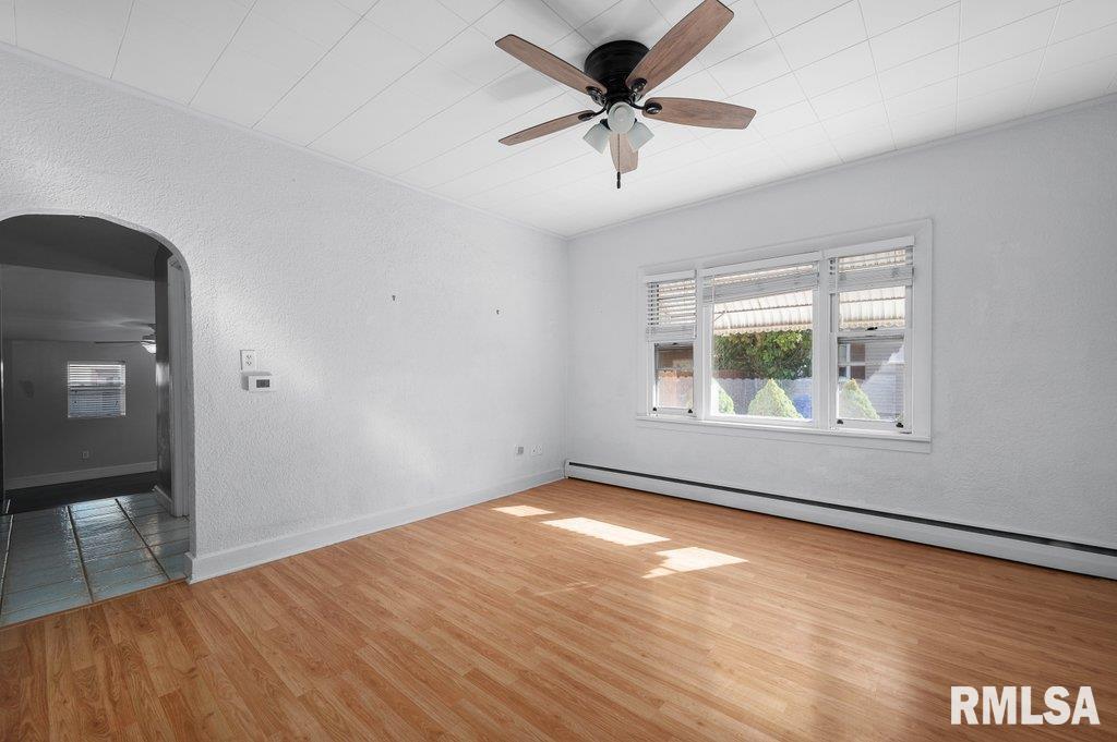 216 North Boss Street Kewanee, IL 61443 - Photo 19 of 36 a view of an empty room with a window and wooden floor