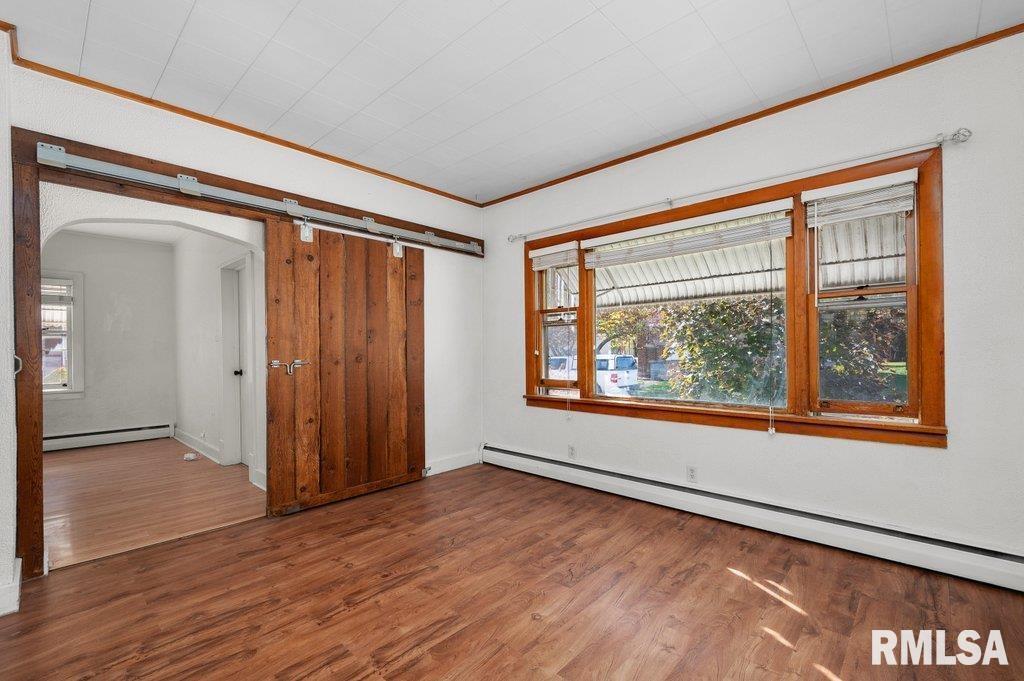 216 North Boss Street Kewanee, IL 61443 - Photo 21 of 36 an empty room with wooden floor and windows