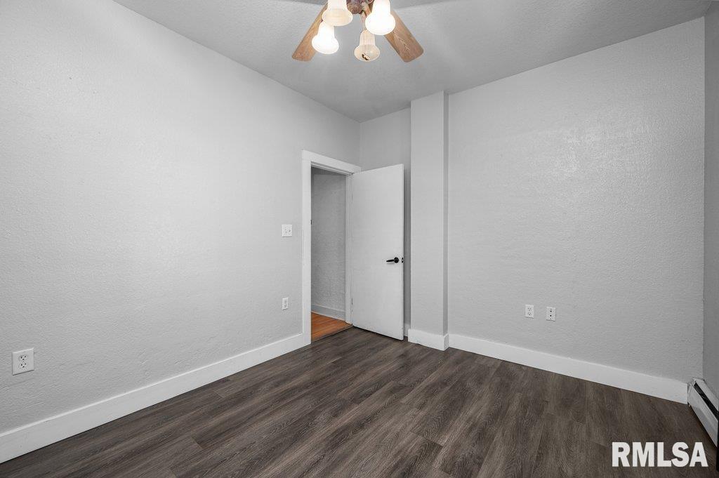 216 North Boss Street Kewanee, IL 61443 - Photo 24 of 36 an empty room with wooden floor and windows