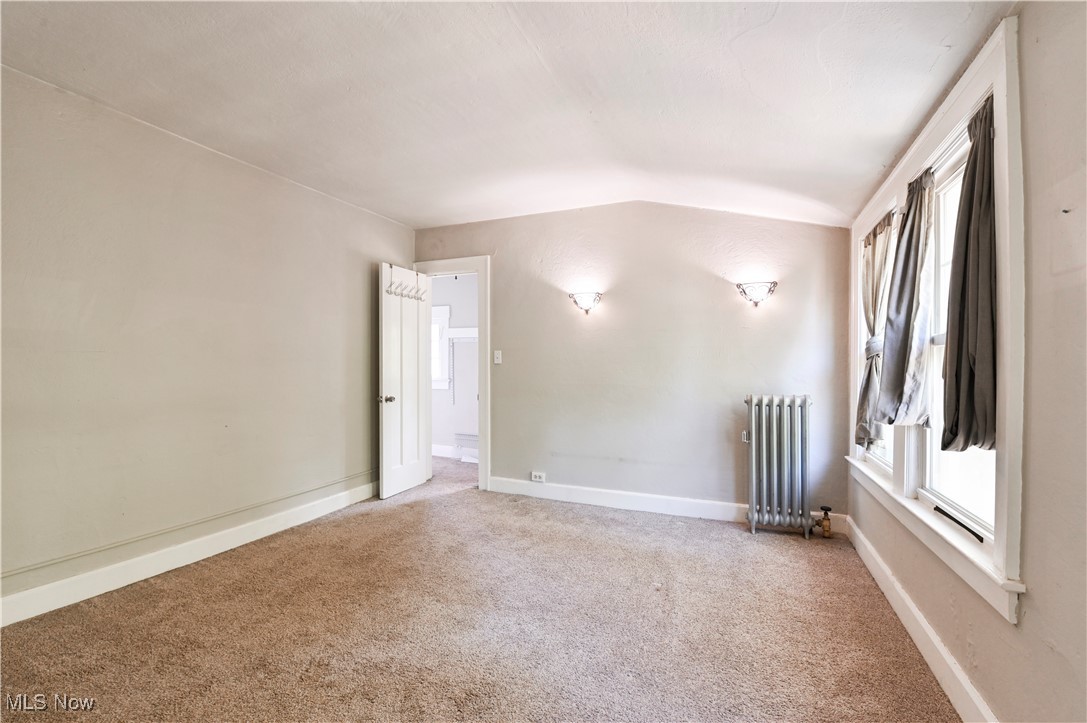 1584 Rydalmount Road Cleveland Heights, OH 44118 - Photo 23 of 36 Spare room with radiator heating unit, carpet flooring, lofted ceiling, and baseboards
