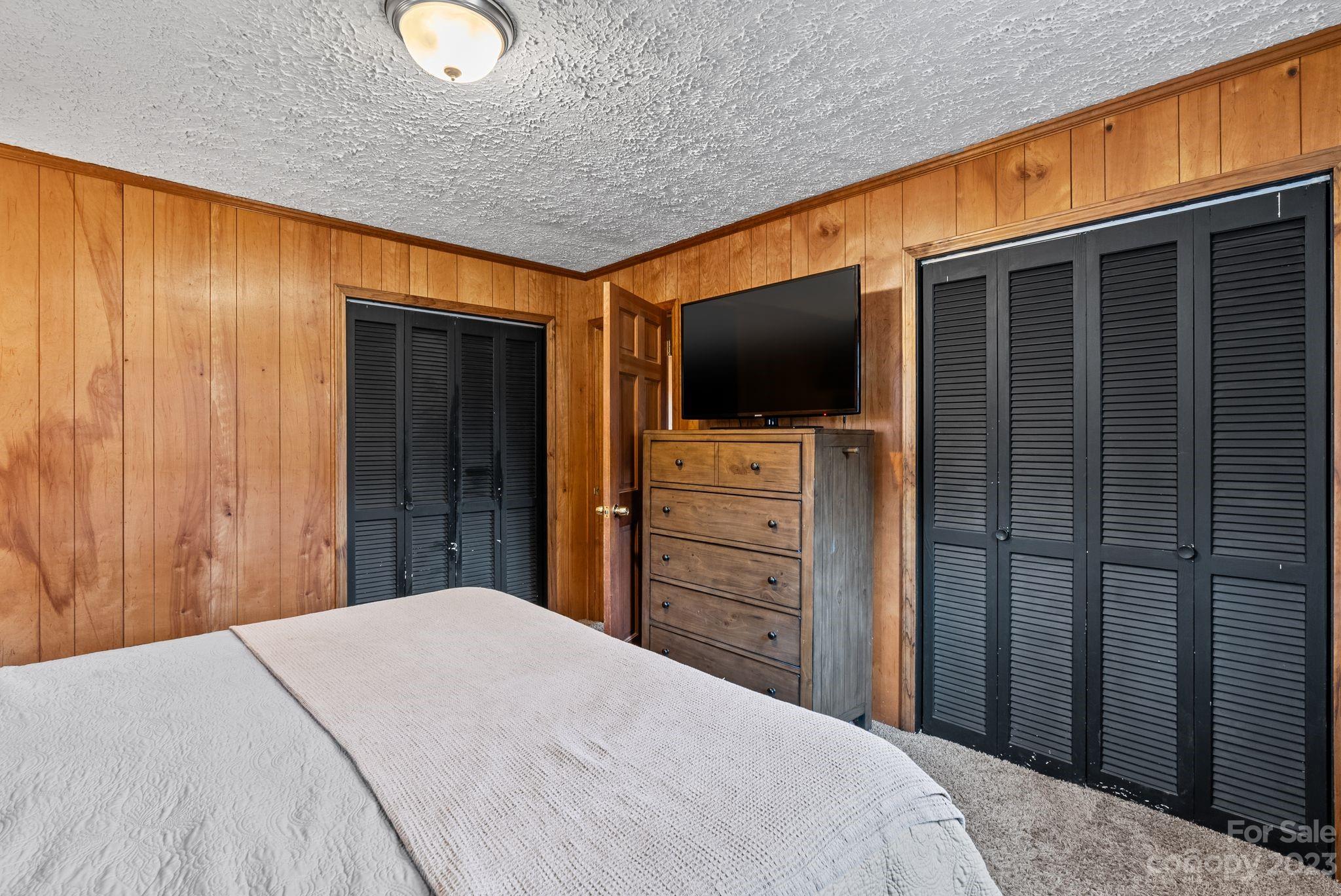 314 Moody Ridge Road Clyde, NC 28721 - Photo 12 of 41 a bedroom with a bed and a flat screen tv