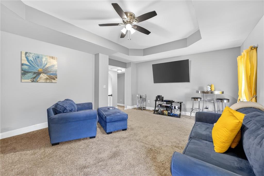 2300 Tucker Mill Road Southwest Conyers, GA 30094 - Photo 30 of 45 a living room with furniture and a flat screen tv