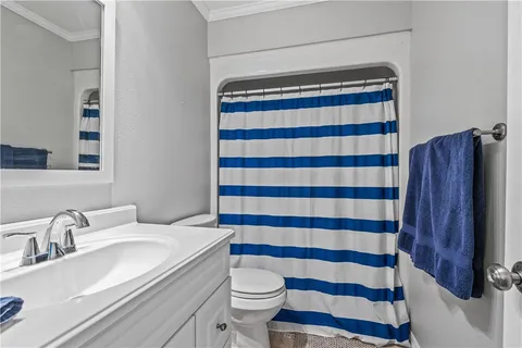 a bathroom with a sink a toilet a shower and a mirror