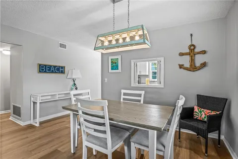 a view of a dining room with furniture wooden floor and a chandelier