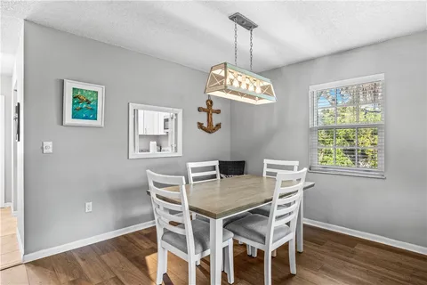 a view of a dining room with a table and chairs