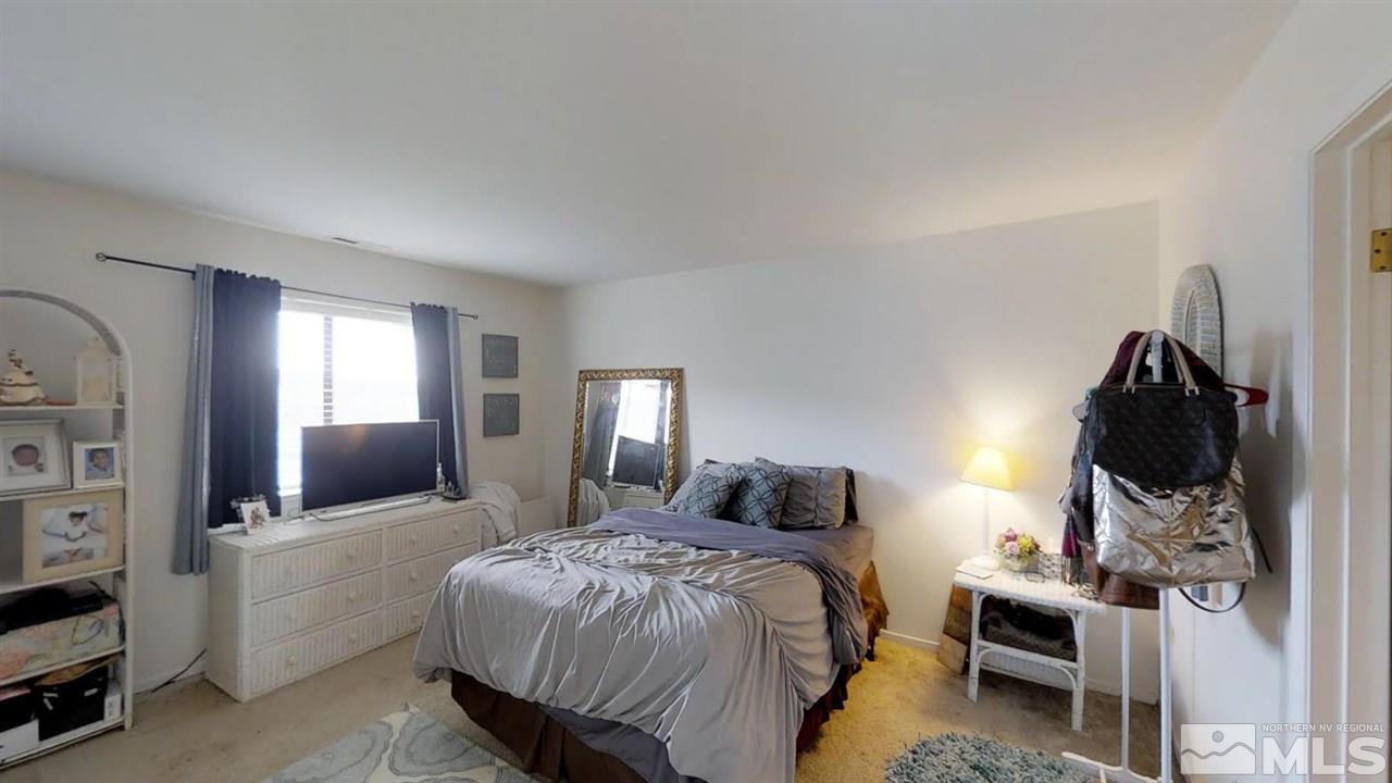 3969 Kings Row Reno, NV 89503 - Photo 8 of 14 a bedroom with a bed and a mirror