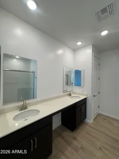 a bathroom with a sink double vanity granite and a mirror
