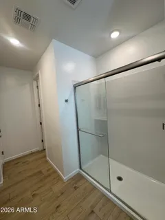 a bathroom with a glass shower door