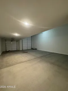 an empty room with a wooden floor and window